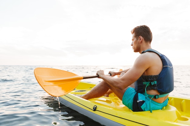  man kayaking on lake sea in boat.