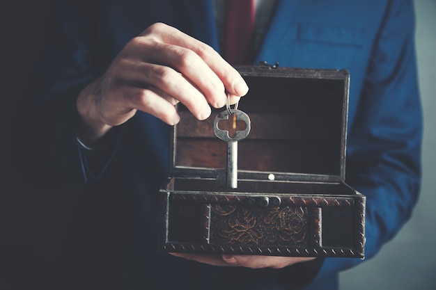 Man keeping key in a wooden box