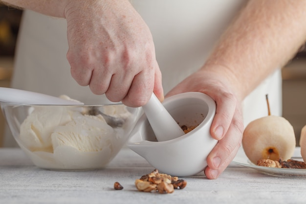 Man in kitchen is grinding spices