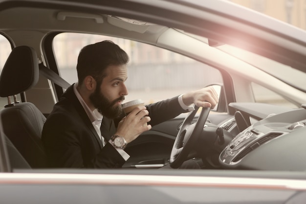 Man koffie drinken in een auto