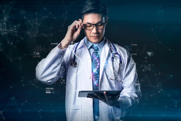 A man in a lab coat is holding a tablet and looking at the screen.