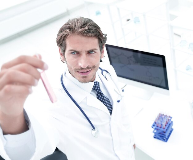 Man in laboratory checking test tubes