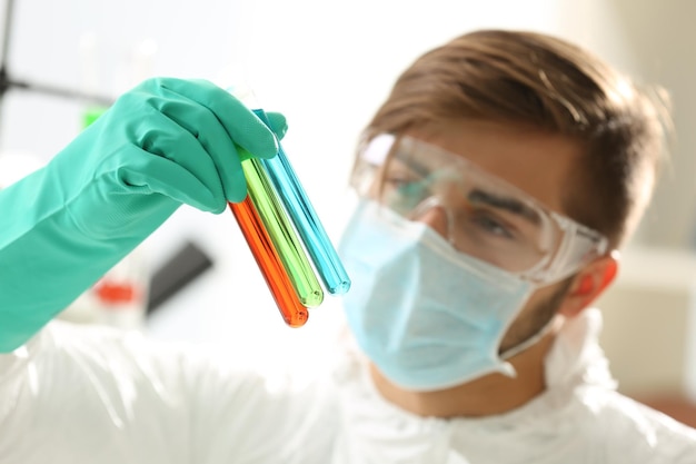 Man in laboratory checking test tubes