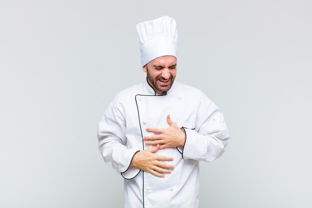 Man laughing out loud at some hilarious joke, feeling happy and cheerful, having fun