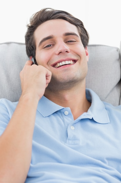 Man laughing while being on the phone