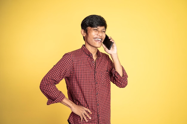 Man laughing while making phone call on isolated background