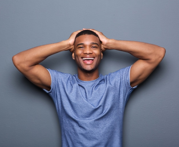 Man laughing with hands on head