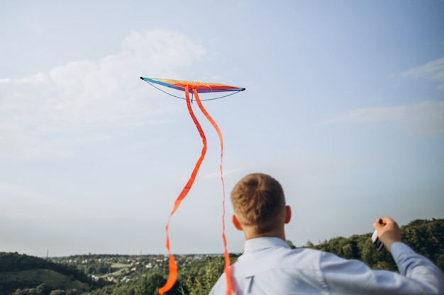 Man launching colorful air kite on the field