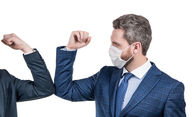 Man lawyer in face mask touch elbows with colleague using coronavirus greeting elbow bump