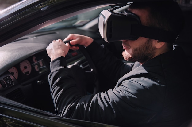 Man learning to drive with virtual reality glasses