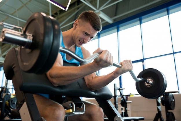 Man Lifting Heavy Barbell with Effort