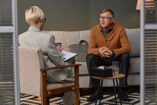 Man listening to female psychologist