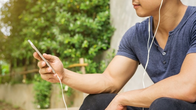 Man listening to a music from a smartphone.