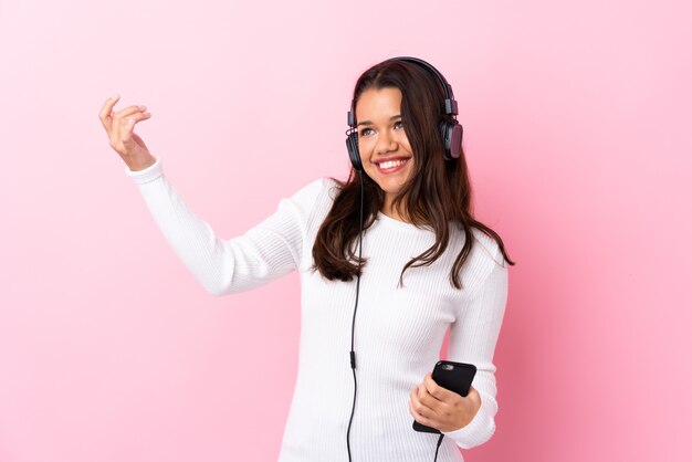 Man listening music over isolated wall