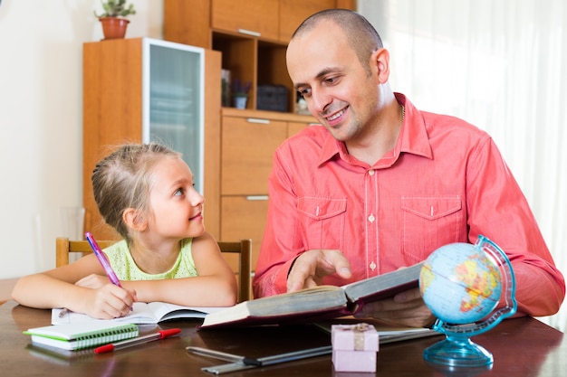 Man and little girl with books indoors&#xA;