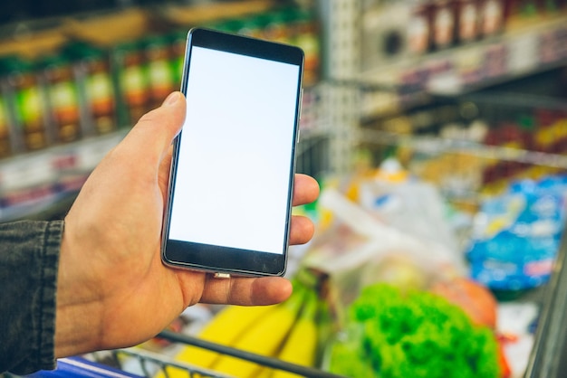 Man look into phone for a shopping list