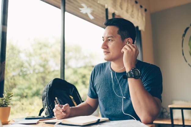 Man looking away while sitting on table