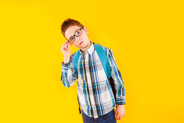 Man looking away while standing against yellow background