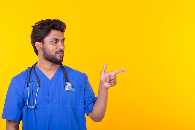 Man looking away while standing against yellow background