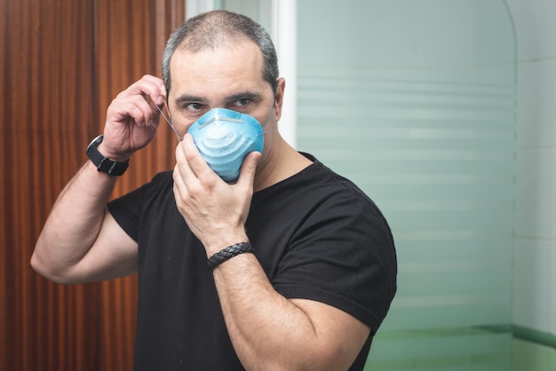 Man looking away while wearing pollution mask