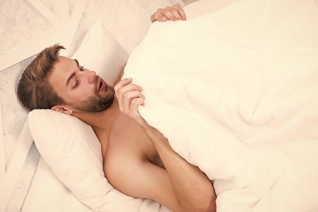 Man looking under blanket Morning wood formally known nocturnal penile tumescence common occurrence Male reproductive system Why men get morning erections Normal erections occur Guy relax in bed