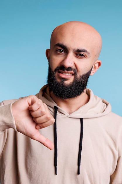 Man looking at camera with thumb down