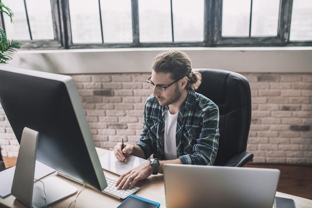 Man looking concentrated on monitor