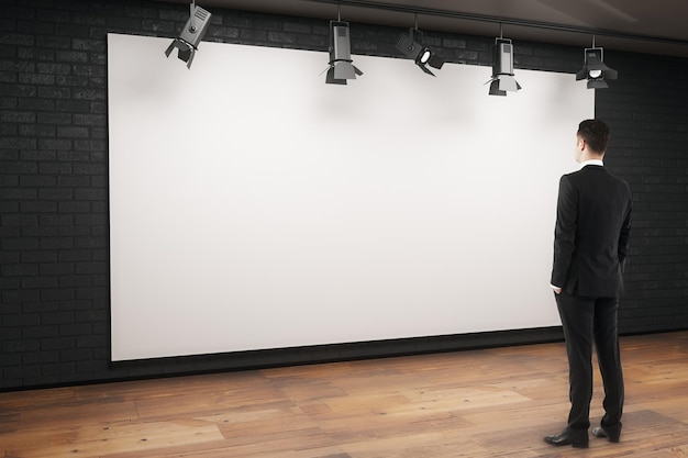 Photo man looking at empty billboard