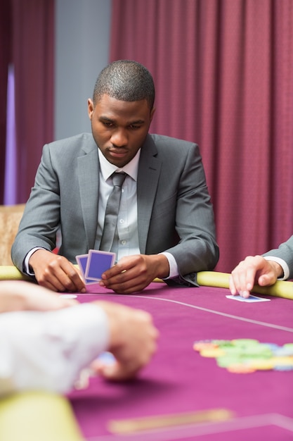 Man looking at his cards