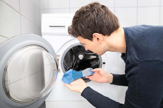 Man Looking For Missing Socks In Washing Mashine And Found Only One Blue Sock