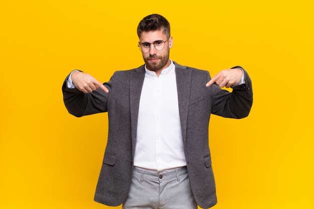 man looking proud, positive and casual pointing to chest with both hands
