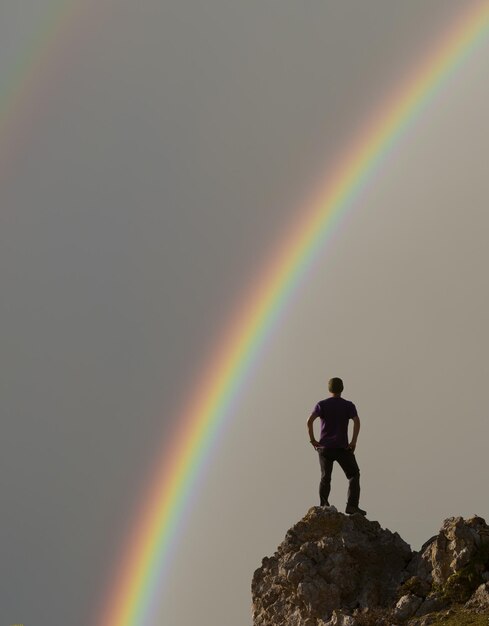 Man looking at the rainbow