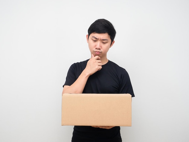 Man looking at shopping box in his hand thinking about something