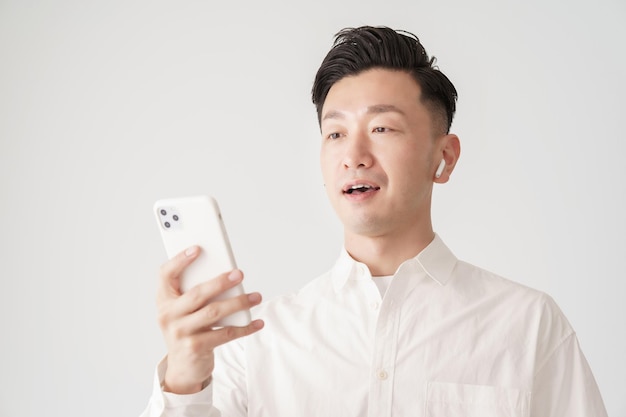 A man looking at a smartphone screen indoors