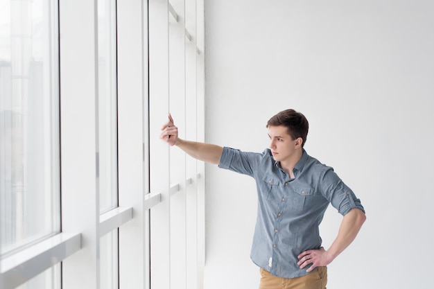 Photo man looking through window in room