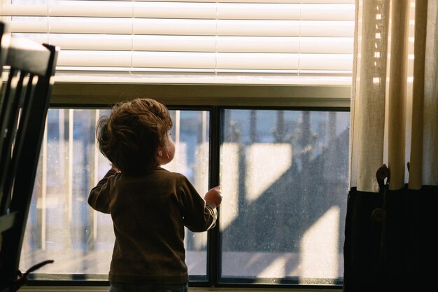 Man looking through window