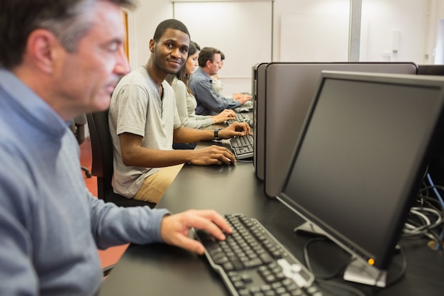 Man looking up from computer class