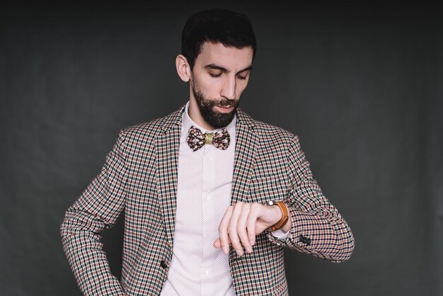 Man looking at watch and calculating time