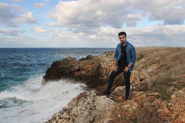 Man looks out to sea from coastal area