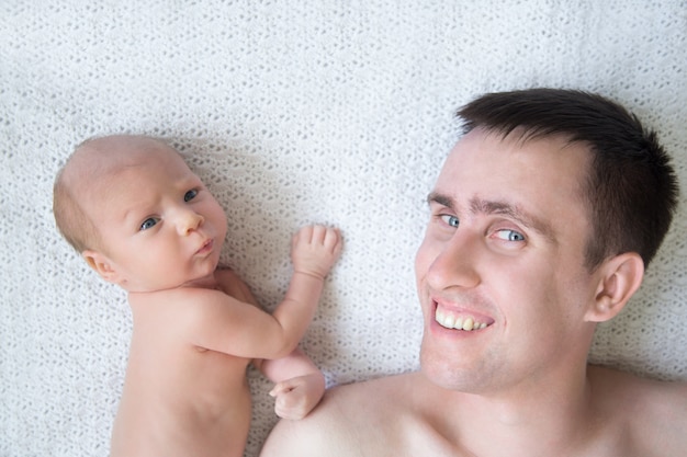 Man lying in bed with a baby