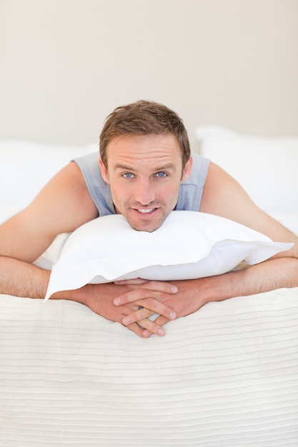 Man lying down on his bed