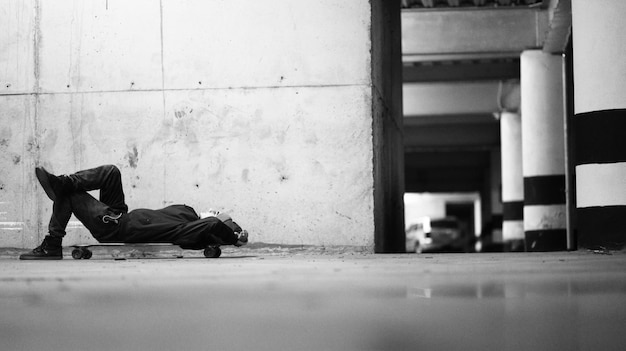 Man lying down on skateboard over floor
