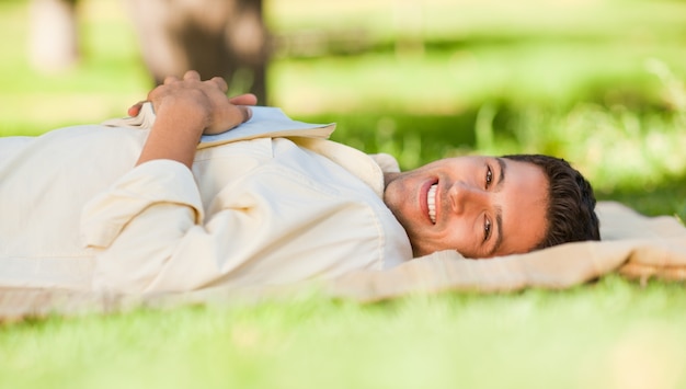 Man lying in the park with his book