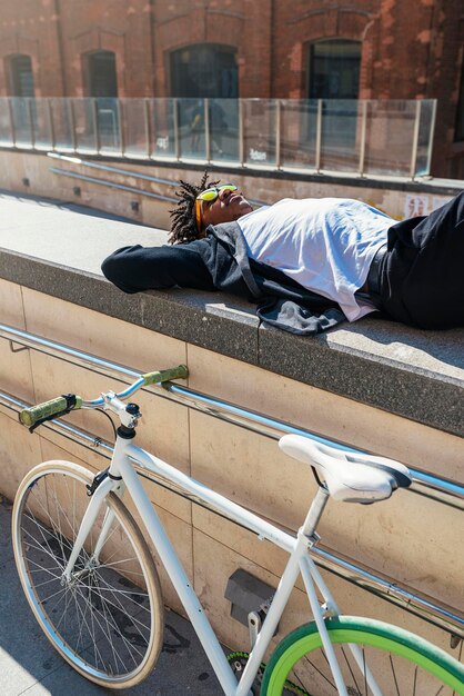 Foto uomo sdraiato sul muro di sostegno