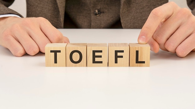 Photo man made word toefl with wooden blocks
