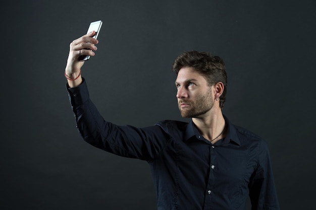 Man make video call with smartphone. Businessman in shirt with mobile phone. Blog and weblog in social network. New technology for modern life and business communication.