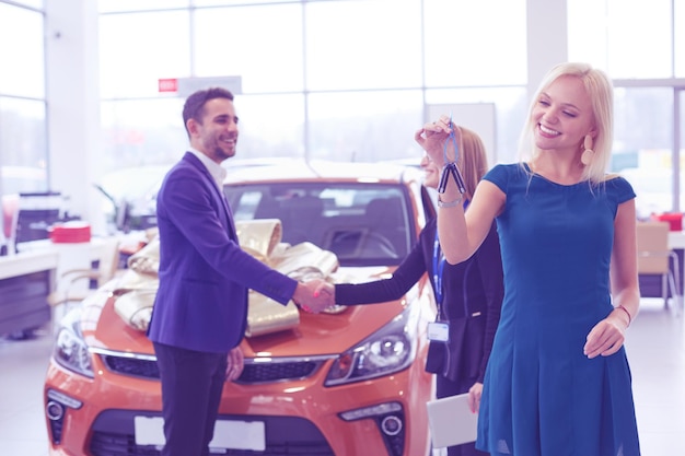 A man makes a gift a car to his wife she is surprised at this they are very happy about this