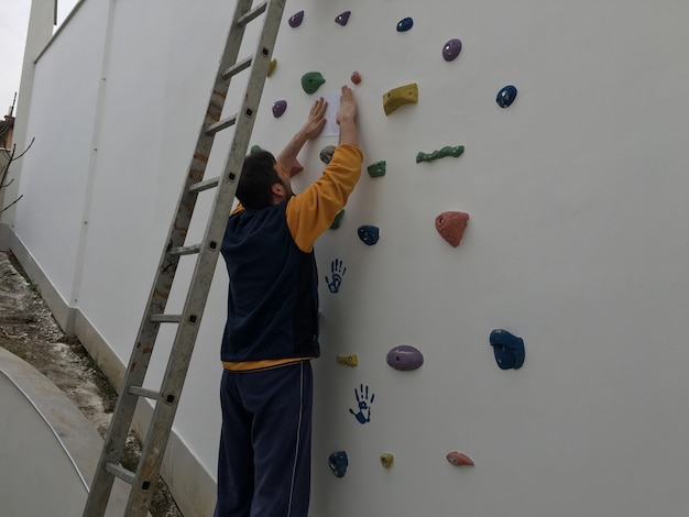 Man making art design on wall