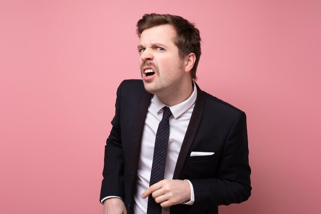 Man making bothered face listening without lack of interest or with disbelief