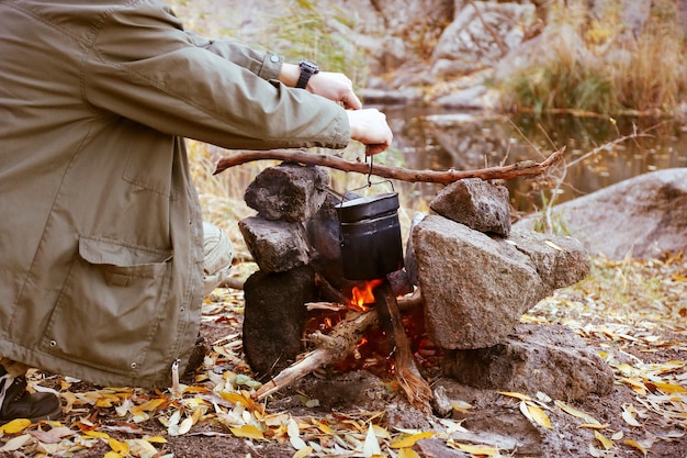 Man making fire in mountains